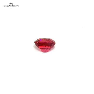 A rare Mahenge spinel gemstone resting on a white turntable, reflecting light from multiple angles.